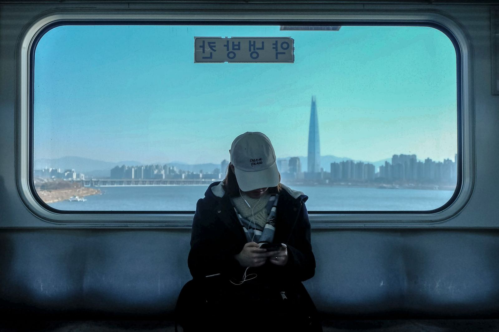 Seoul subway passenger with the Han River and city skyline behind